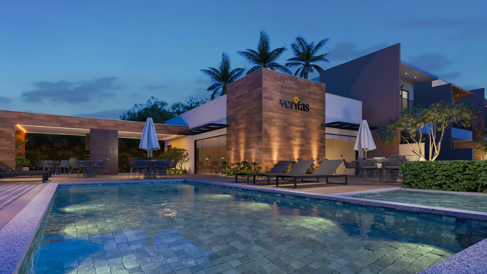 Piscina e salão de festas do Condomínio Veritas iluminados à noite